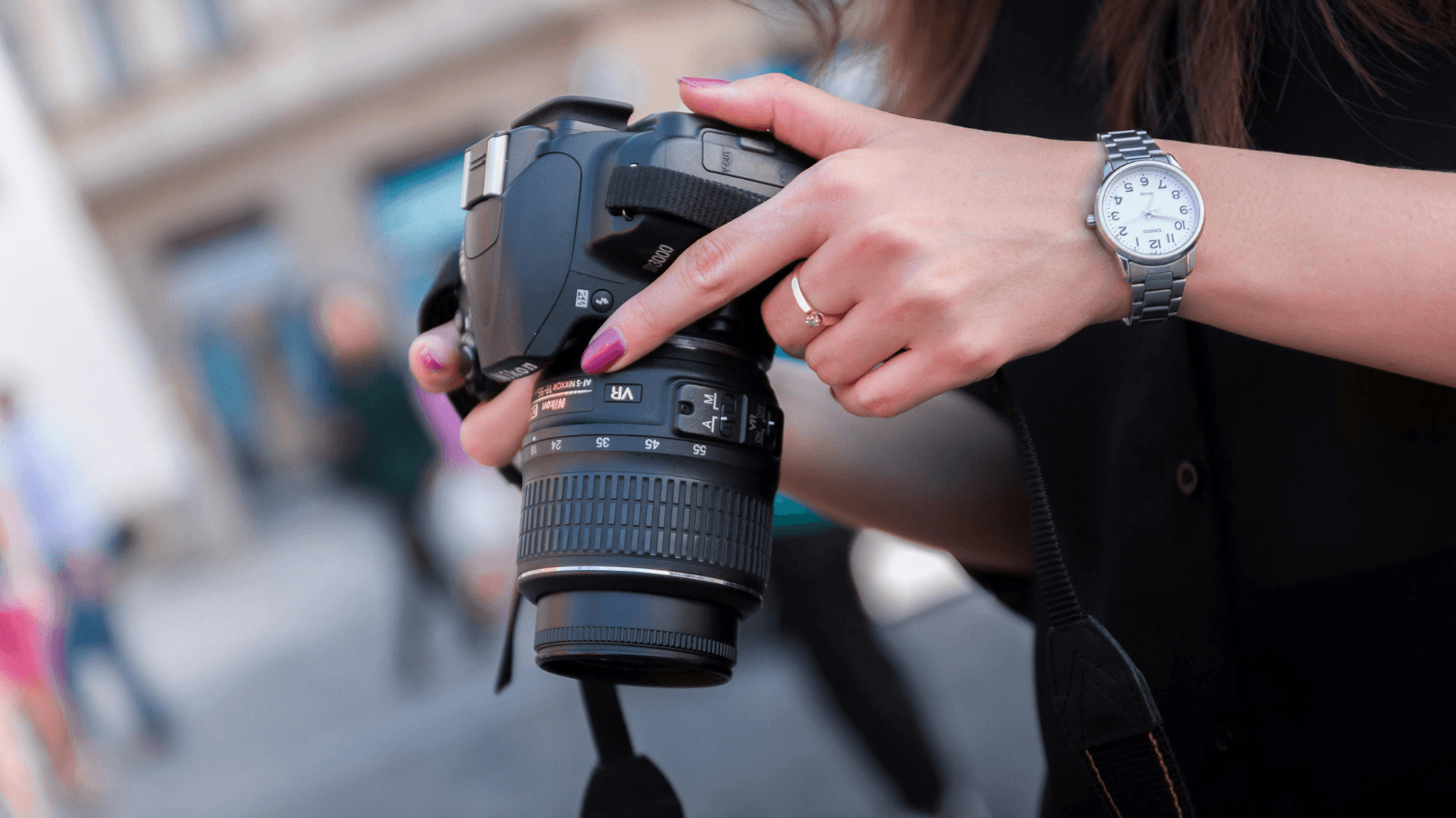 Woman holding a camera for side hustle of photography